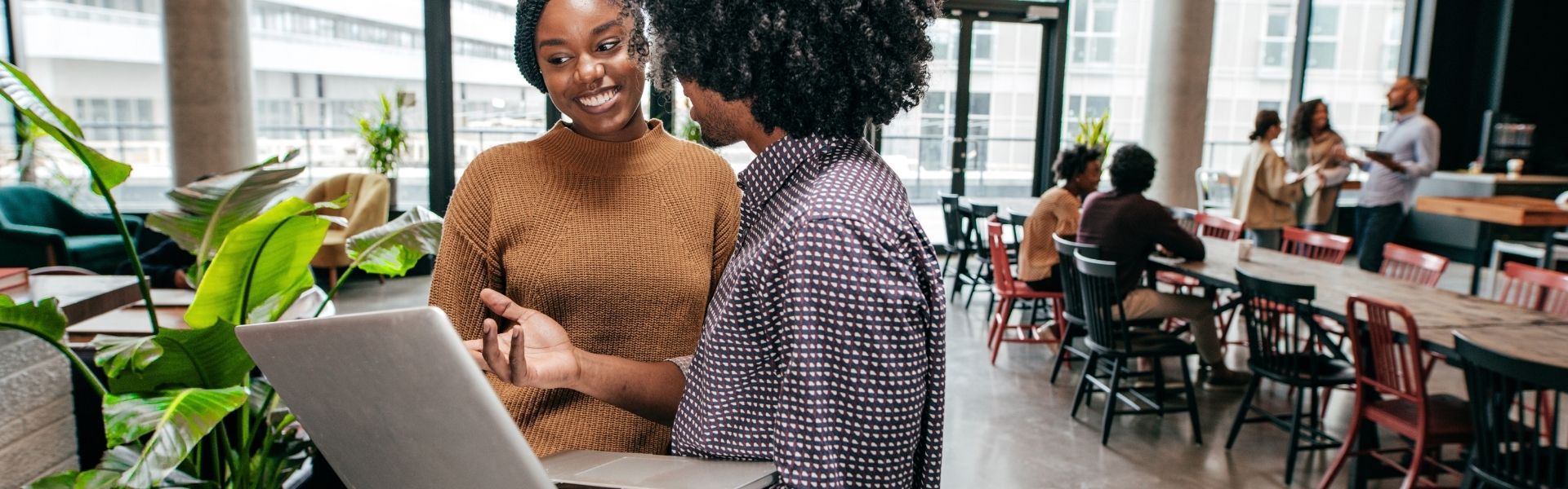 Businesswoman interacting with a virtual screen displaying digital marketing icons and analytics